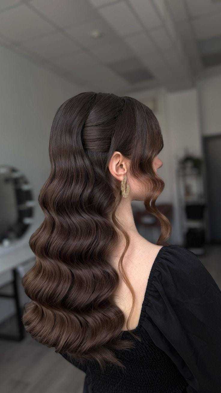Elegant woman with long, wavy brown hair in a salon setting.